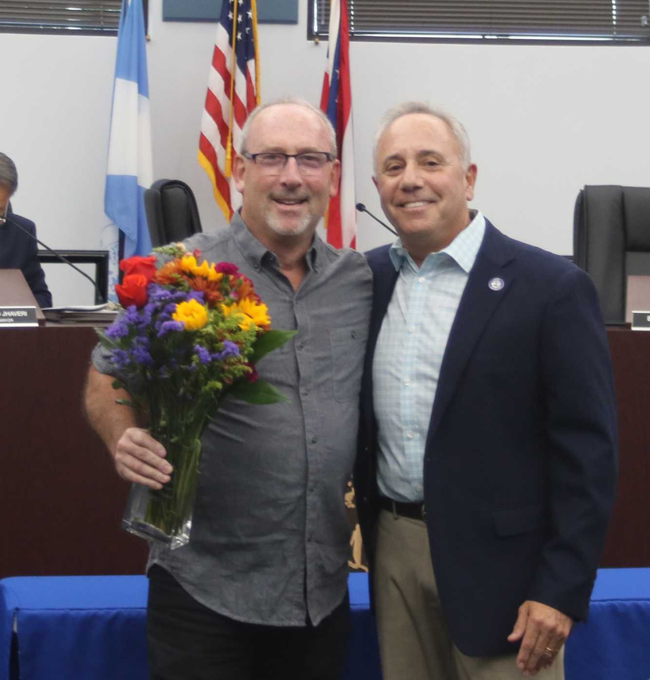 Mr. Kaufman with flowers and Mayor Sirkin